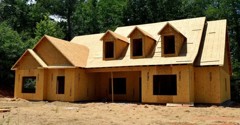 new house wrapped in OSB oriented strand board wall and roof sheathing during framing
