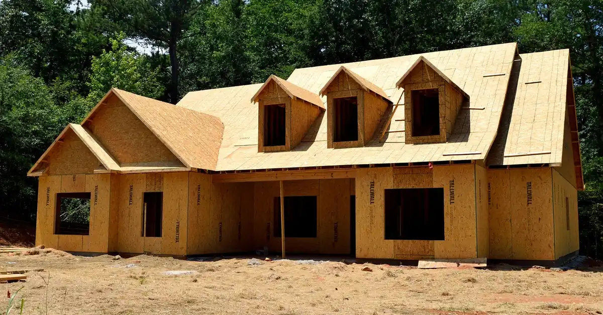 new house wrapped in OSB oriented strand board wall and roof sheathing during framing