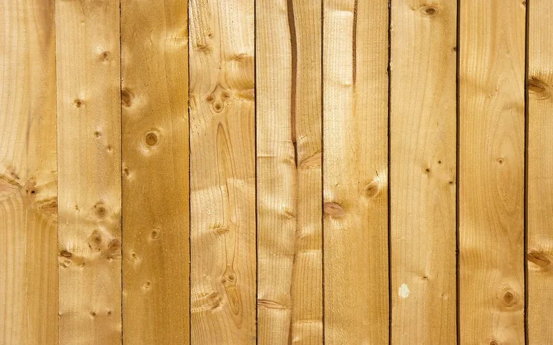 Solid pine lumber planks stacked and ready for a woodworking project