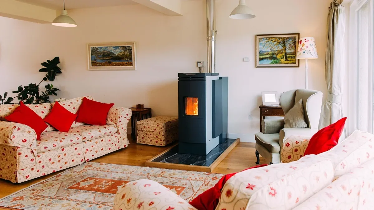Freestanding stove on a hearth pad in a living room, the kind of appliance that carries a safety listing label