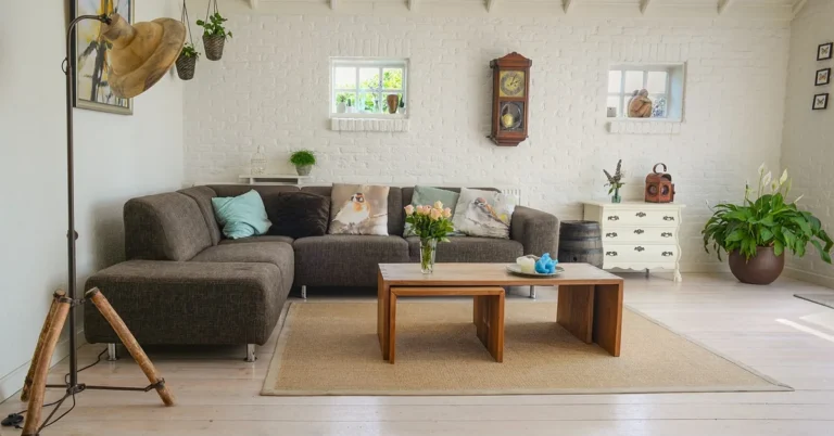 living room with sofa, coffee table, and dresser legs resting on a light hardwood floor