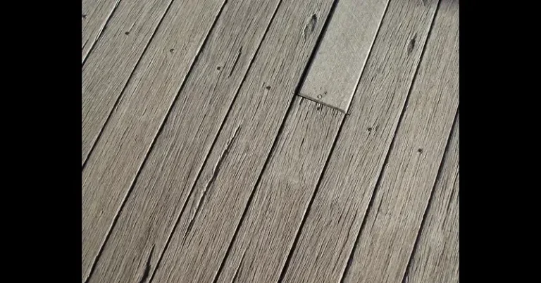 Close-up of capped-polymer composite deck boards showing wood-grain texture