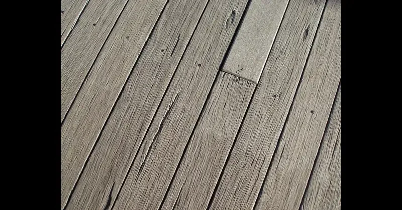 Close-up of capped-polymer composite deck boards showing wood-grain texture