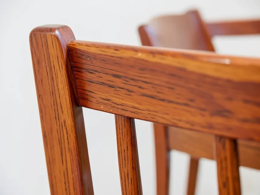 Close-up of a solid cherry wood dining chair back showing grain and joinery