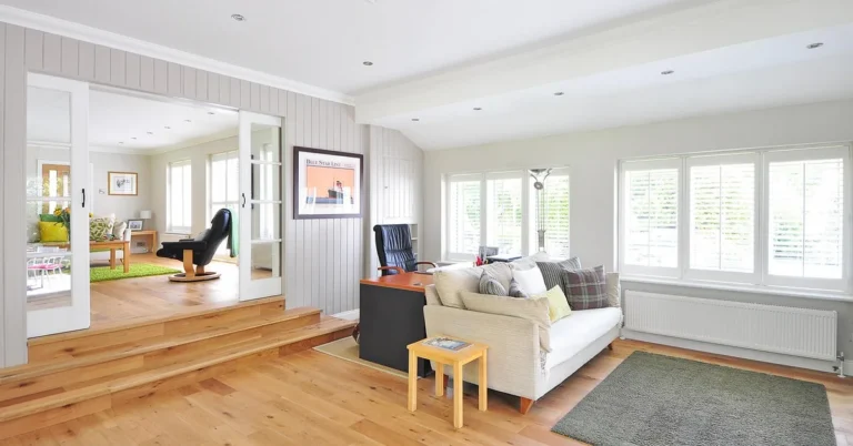 Sofa sitting directly on a wide-plank hardwood floor in a bright living room