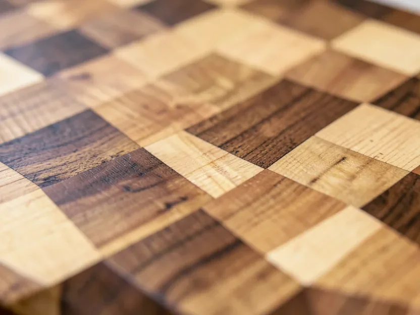 Close-up of end-grain maple and walnut wood cutting board grain pattern