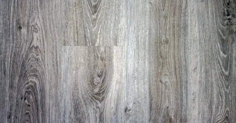 Close-up of gray-toned laminate flooring planks showing printed wood-grain texture