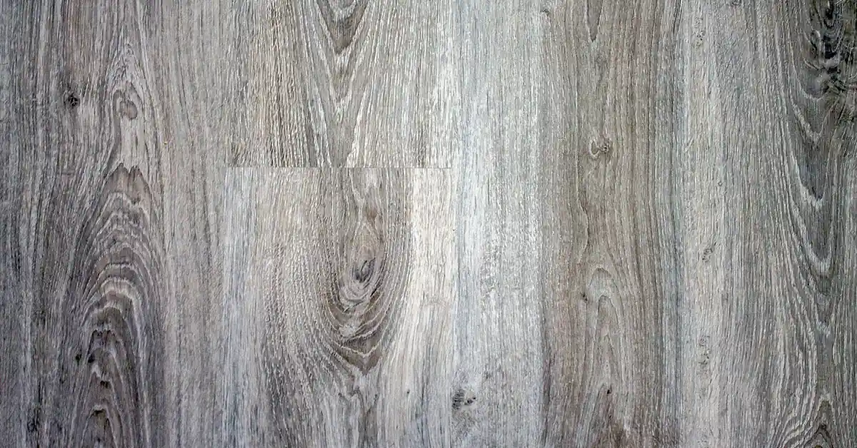 Close-up of gray-toned laminate flooring planks showing printed wood-grain texture