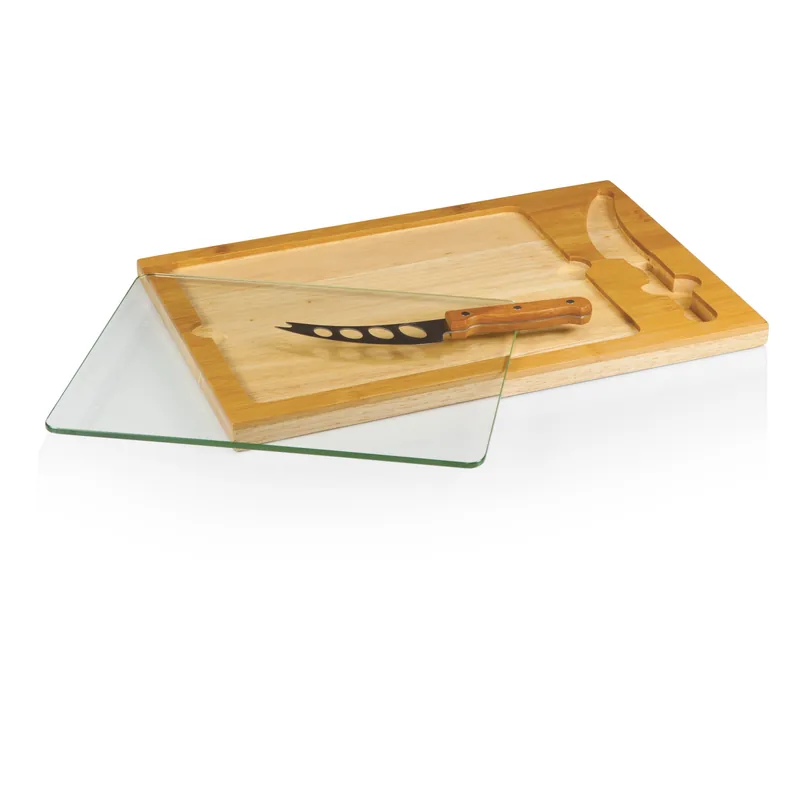Glass cutting board with silicone corner grips and drip tray on a wood counter