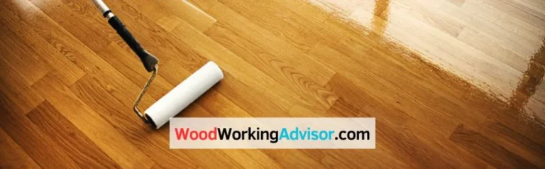 Paint roller on a freshly painted hardwood floor in a warm gold hardwood floor paint color