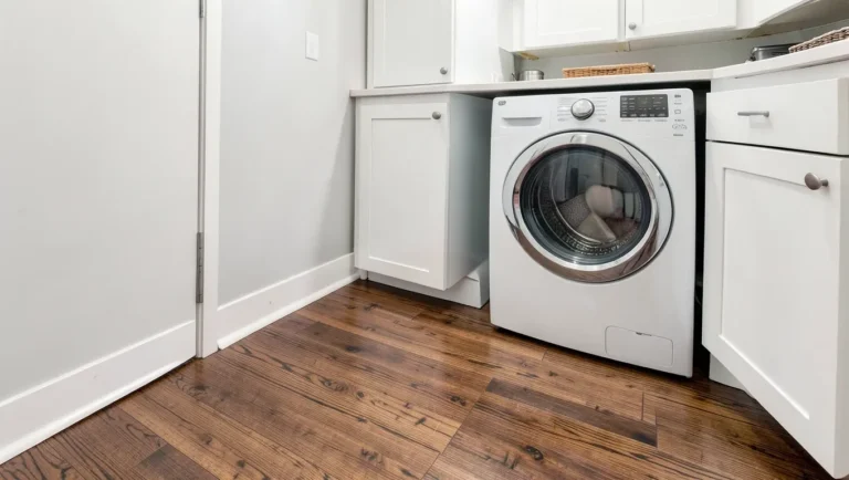 Engineered hardwood is the safer wood-look option for a laundry room
