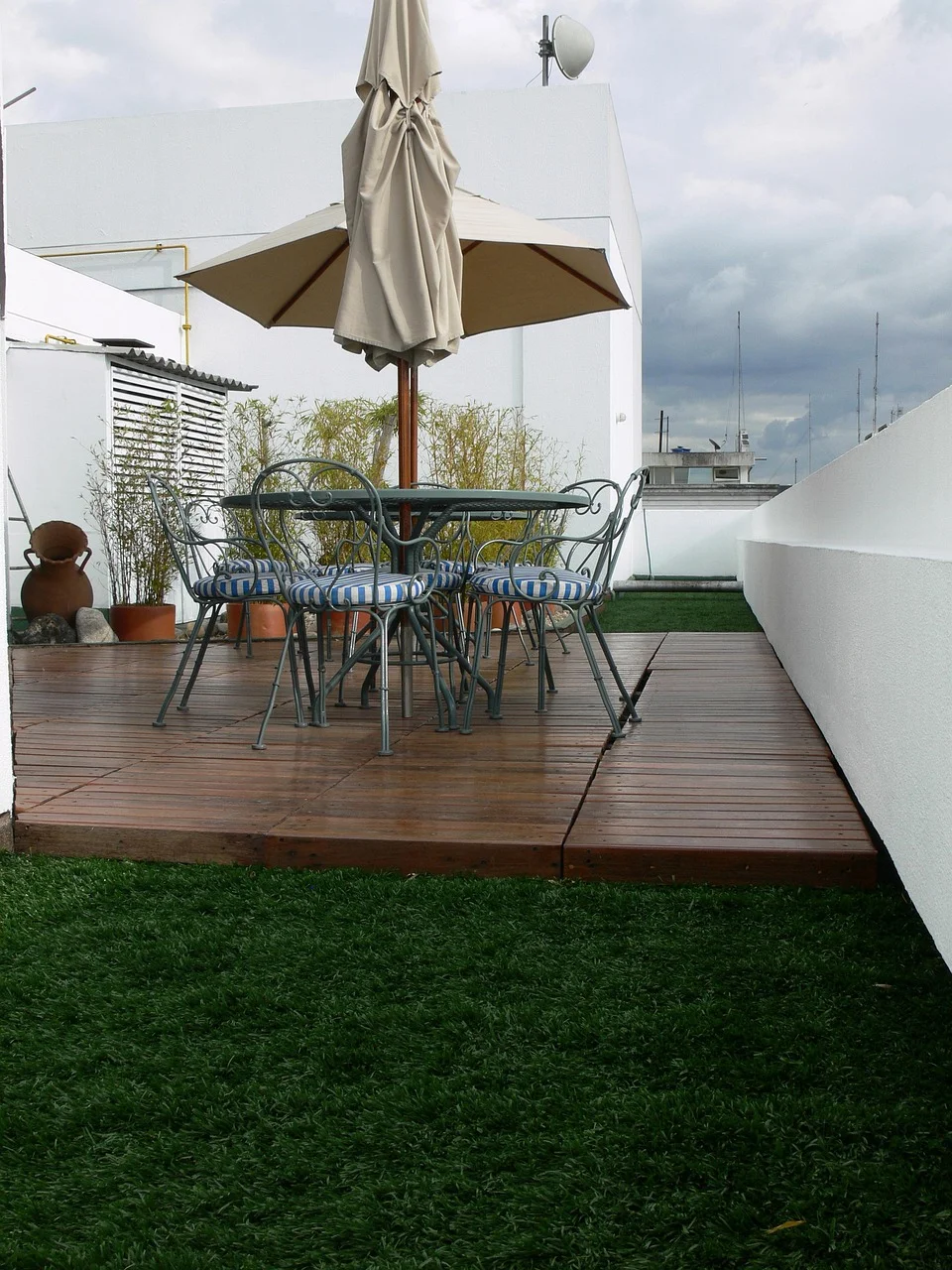 Finished wood deck with outdoor furniture, an example of the deck materials sold at Home Depot