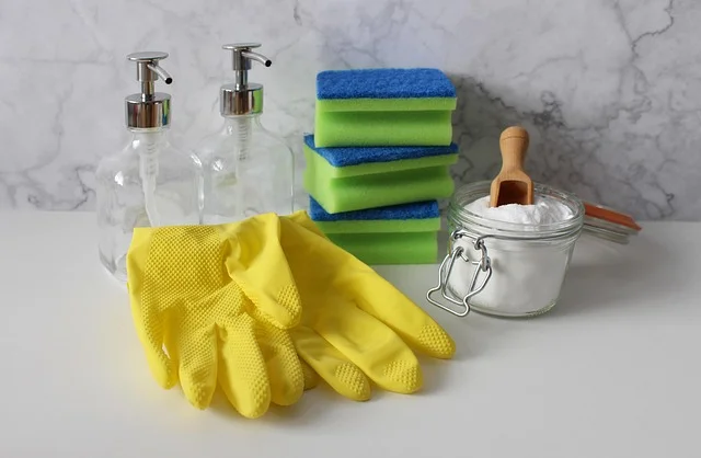 Household cleaning supplies including baking soda, sponges, and gloves