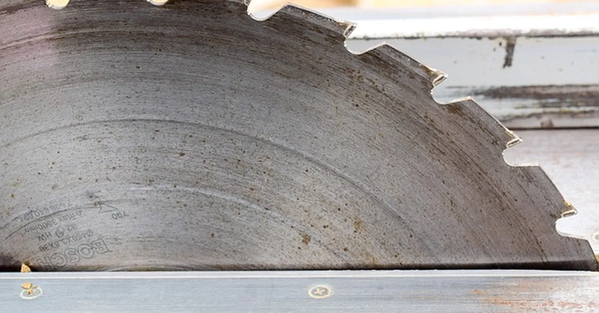 Close-up of a job site table saw blade ready to cut a board