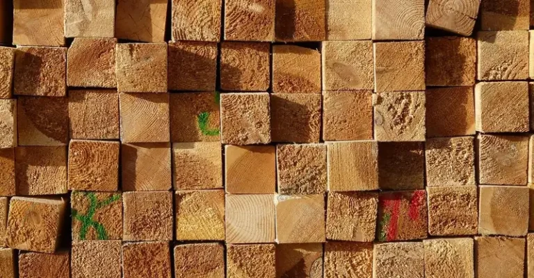 Stack of dimensional lumber ends showing square timber cross sections