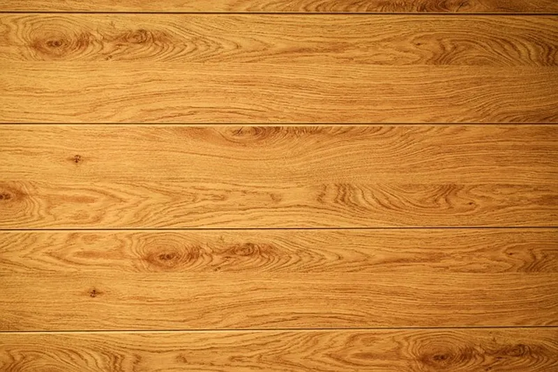 Close-up of oak wood plank grain, the type of surface exterior wood stain colors need to complement