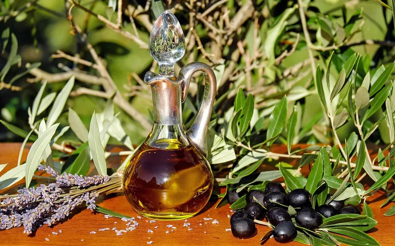 olive oil bottle beside a wood surface, used as a natural adhesive softener olive oil bottle beside a wood surface, used as a natural adhesive softener