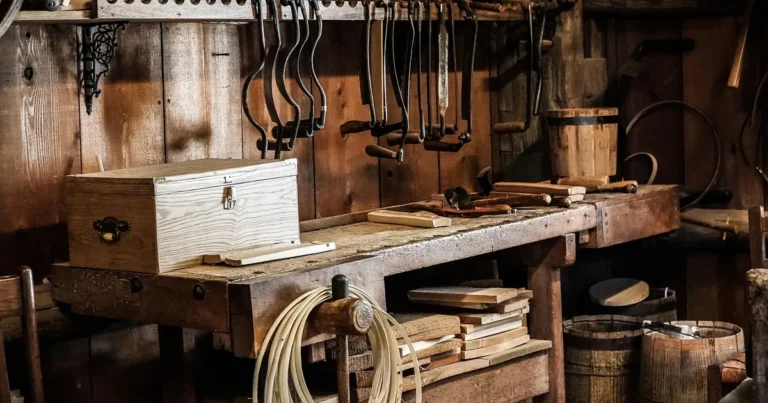 Old woodworking workshop bench with hand tools and a wooden box