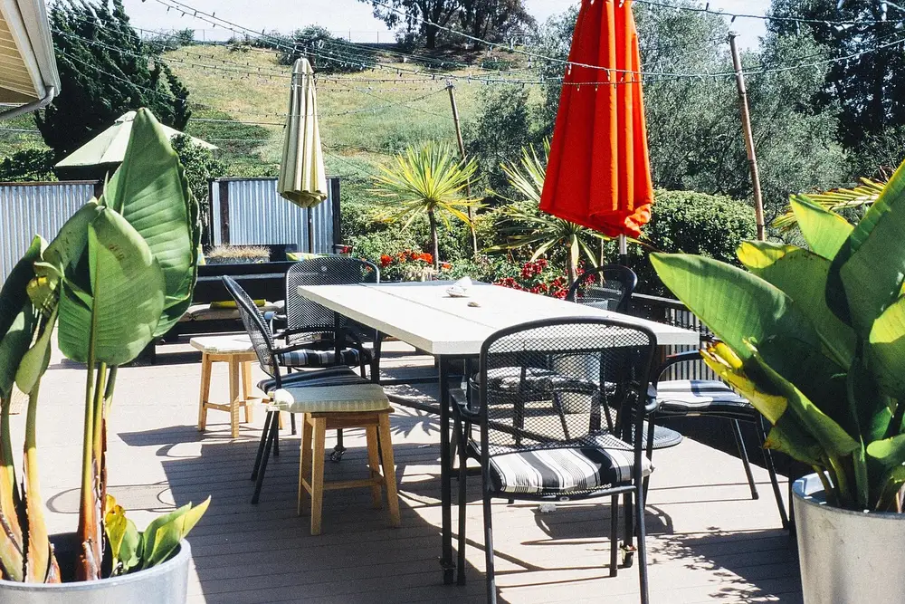 Backyard wood deck with patio furniture and string lights