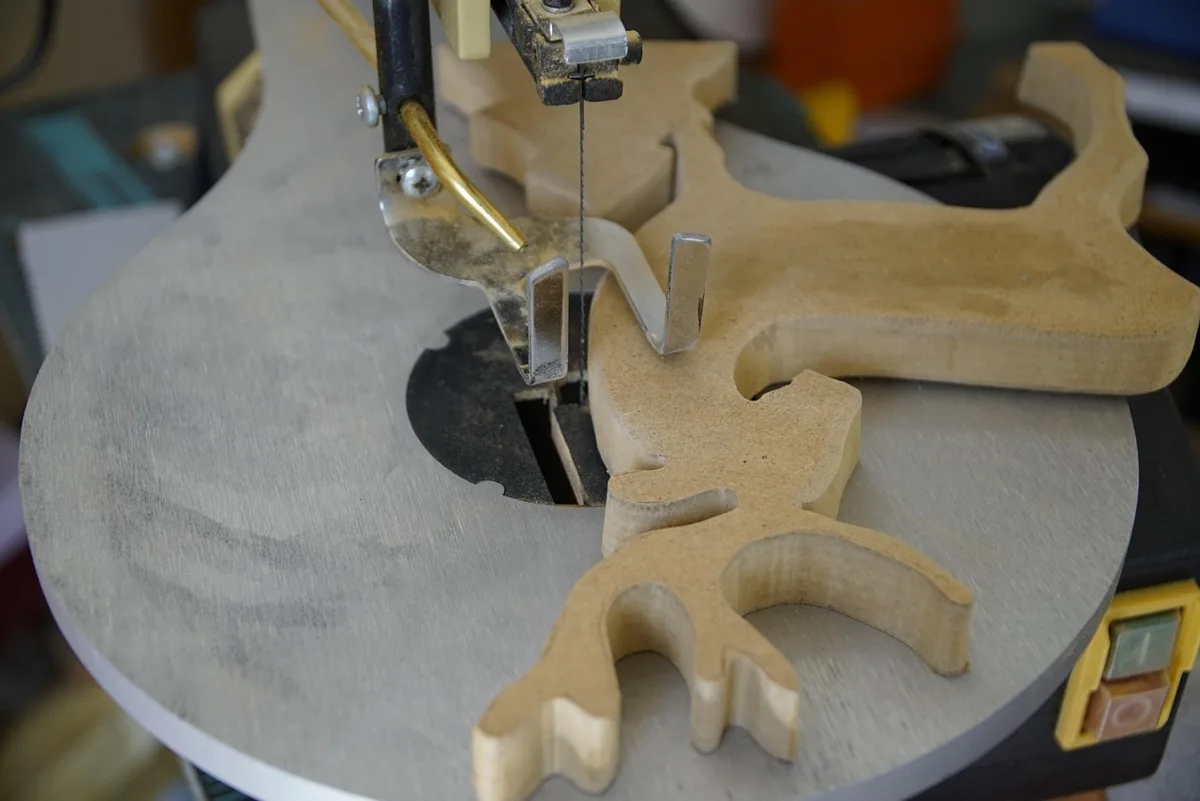 Scroll saw cutting a wood pattern