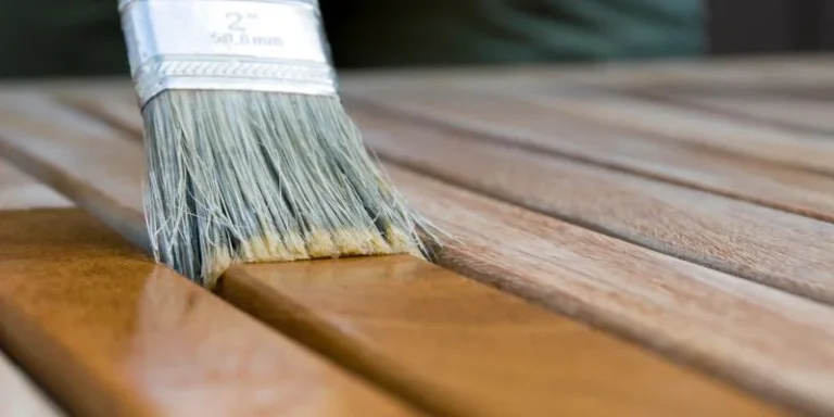Applying wood stain to deck boards with a brush