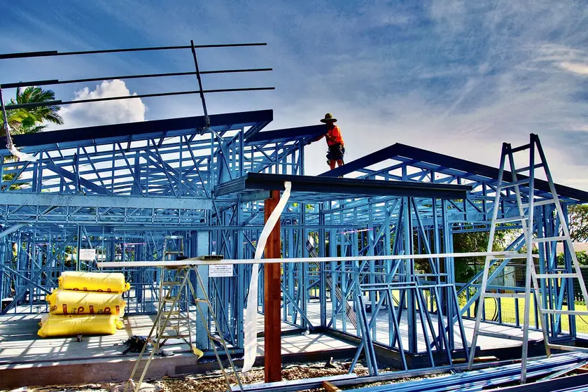 Steel frame construction with black steel joists replacing wood framing on a new build