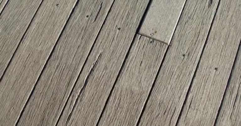 Weathered pressure-treated wood deck boards showing natural graying without stain or sealer