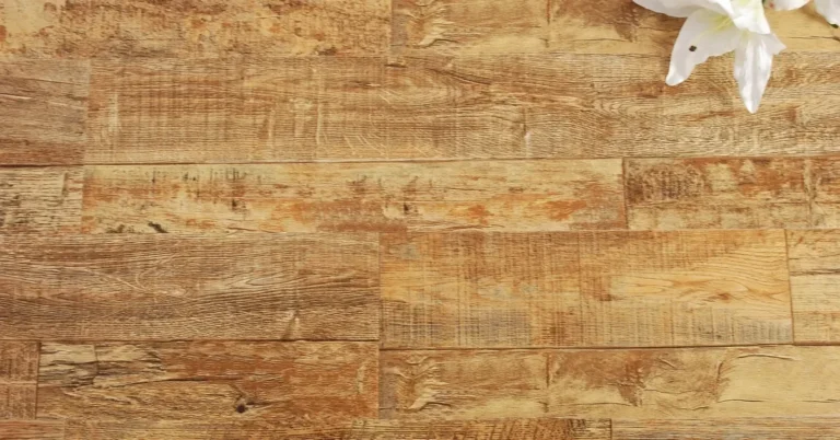 Wood-look plank flooring surface with a lily resting on the planks