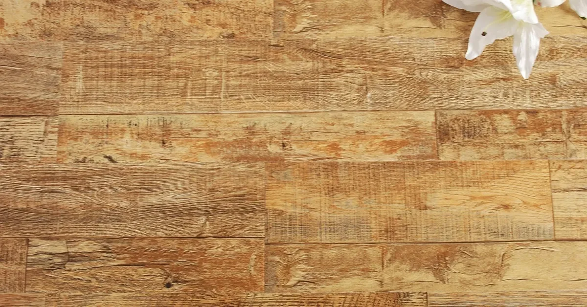 Wood-look plank flooring surface with a lily resting on the planks