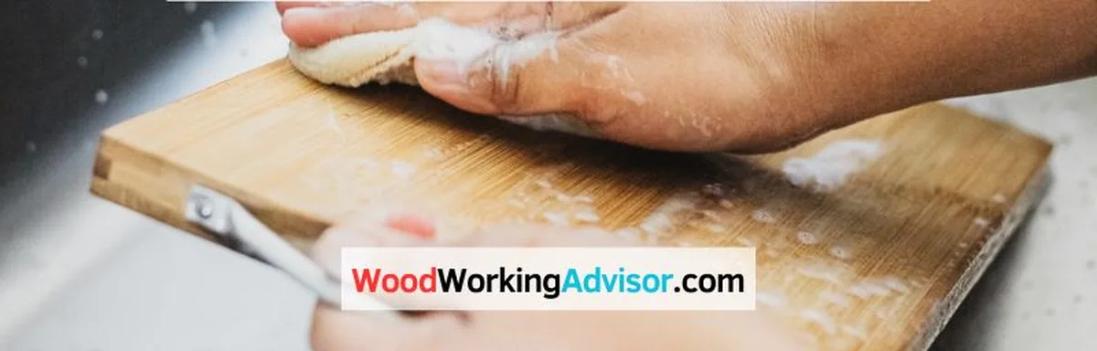 Hands washing a wood cutting board with cleaning spray and soap in the sink
