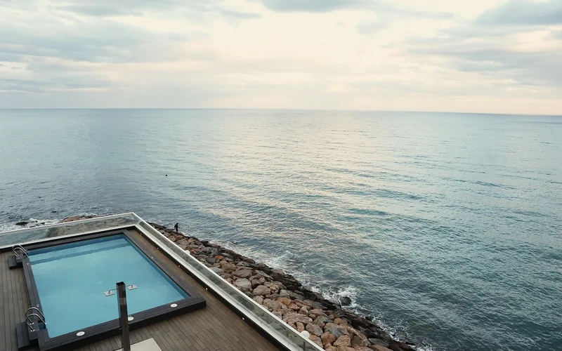 above-ground pool wrapped with a wood deck and railing