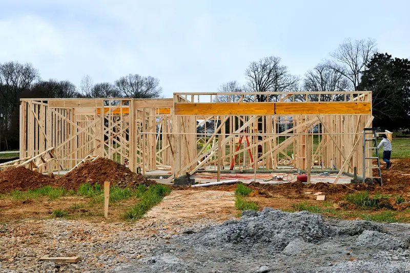 Wood framing of a building under construction with ladders on site Wood framing of a building under construction with ladders on site