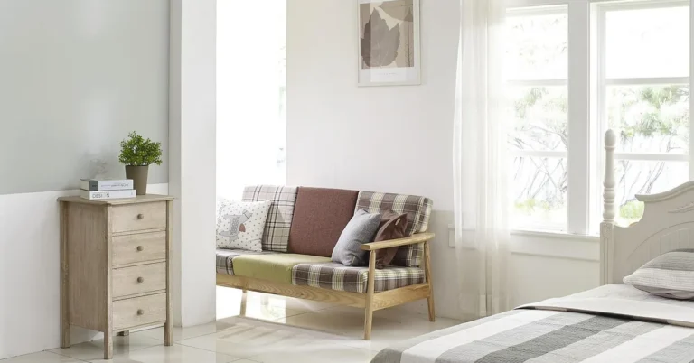 Tall wooden dresser standing against a bedroom wall