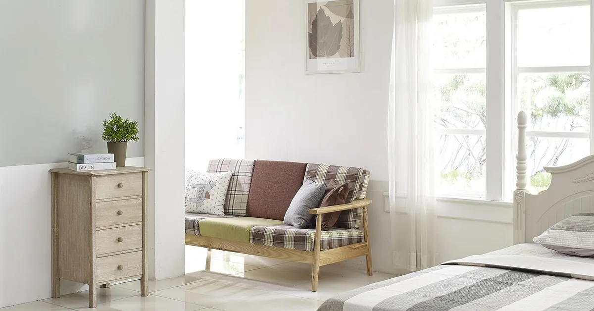 Tall wooden dresser standing against a bedroom wall