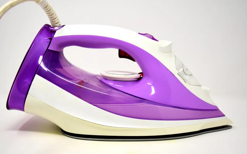 A standard clothes iron set to low, dry heat, used to lift trapped moisture from a veneer finish A standard clothes iron set to low, dry heat, used to lift trapped moisture from a veneer finish