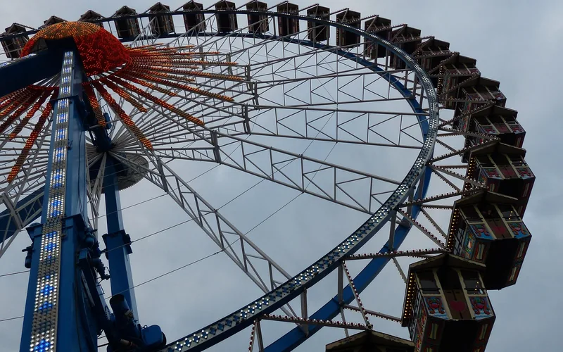 Steel lattice frame of a modern Ferris wheel photographed from below against a cloudy sky Steel lattice frame of a modern Ferris wheel photographed from below against a cloudy sky