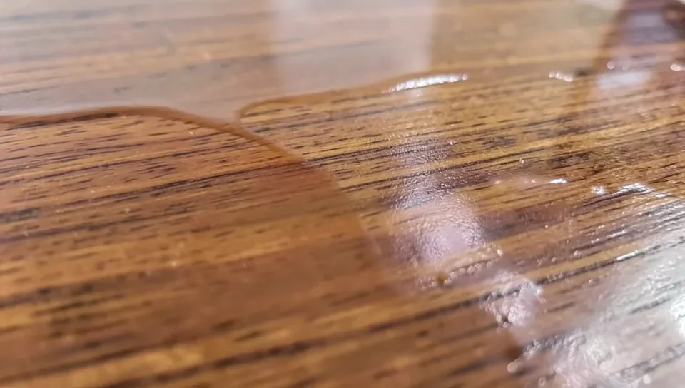 A finished wood panel with a smooth melted PET plastic coating