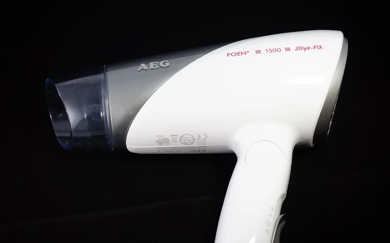handheld hairdryer used on a low heat setting to speed up paint drying on rubber