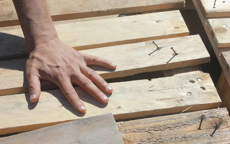 Hand testing the texture and temperature of a wood board as a no-meter moisture check Hand testing the texture and temperature of a wood board as a no-meter moisture check