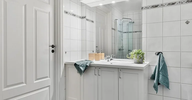White painted vanity cabinet in a modern non-wood bathroom