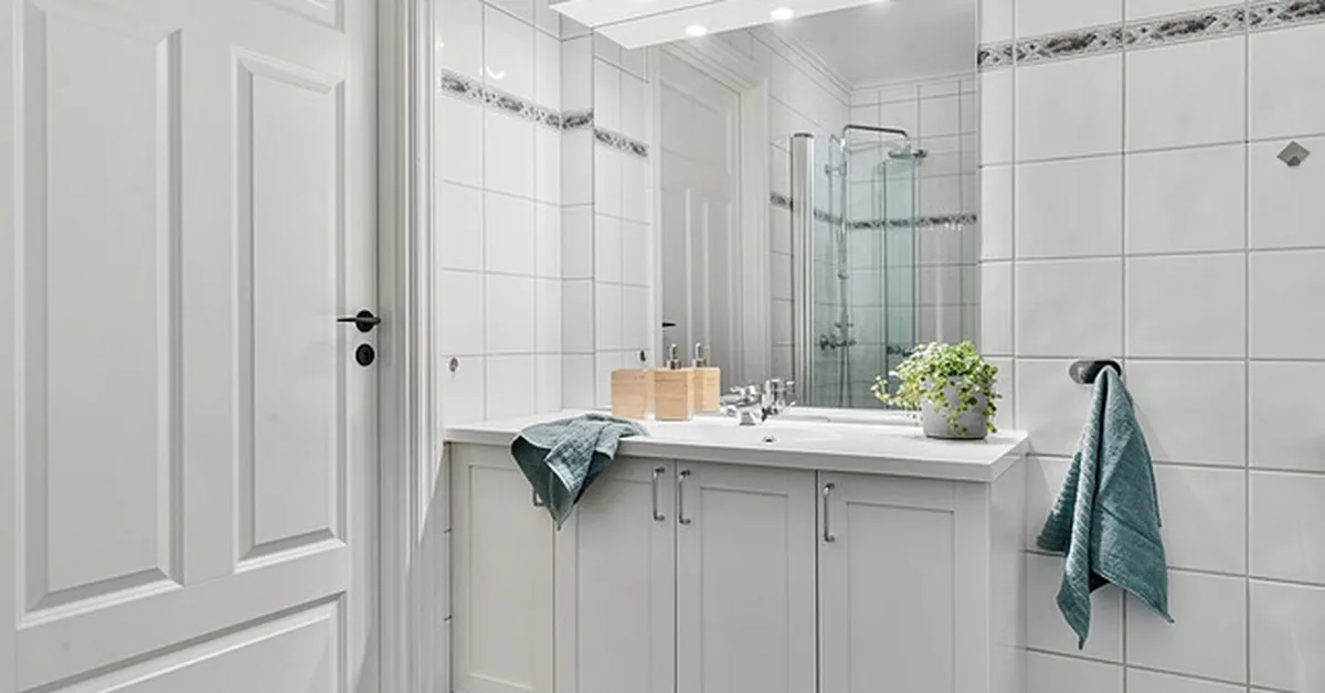 White painted vanity cabinet in a modern non-wood bathroom
