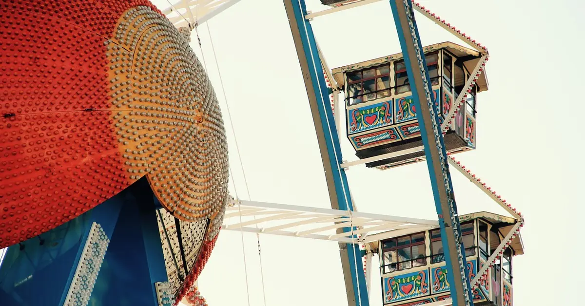 Brightly painted Ferris wheel gondolas at a Bavarian folk festival