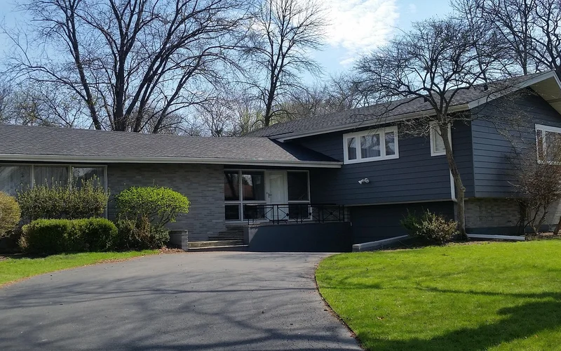 House with freshly painted dark blue lap siding