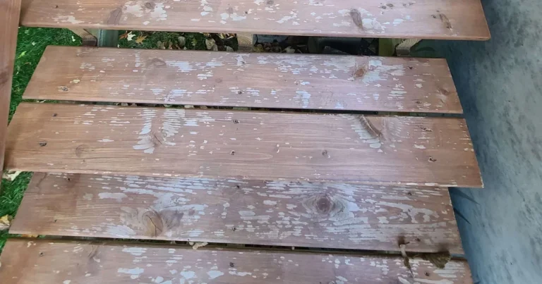 Peeling paint on deck boards caused by painting over wood that had not fully dried