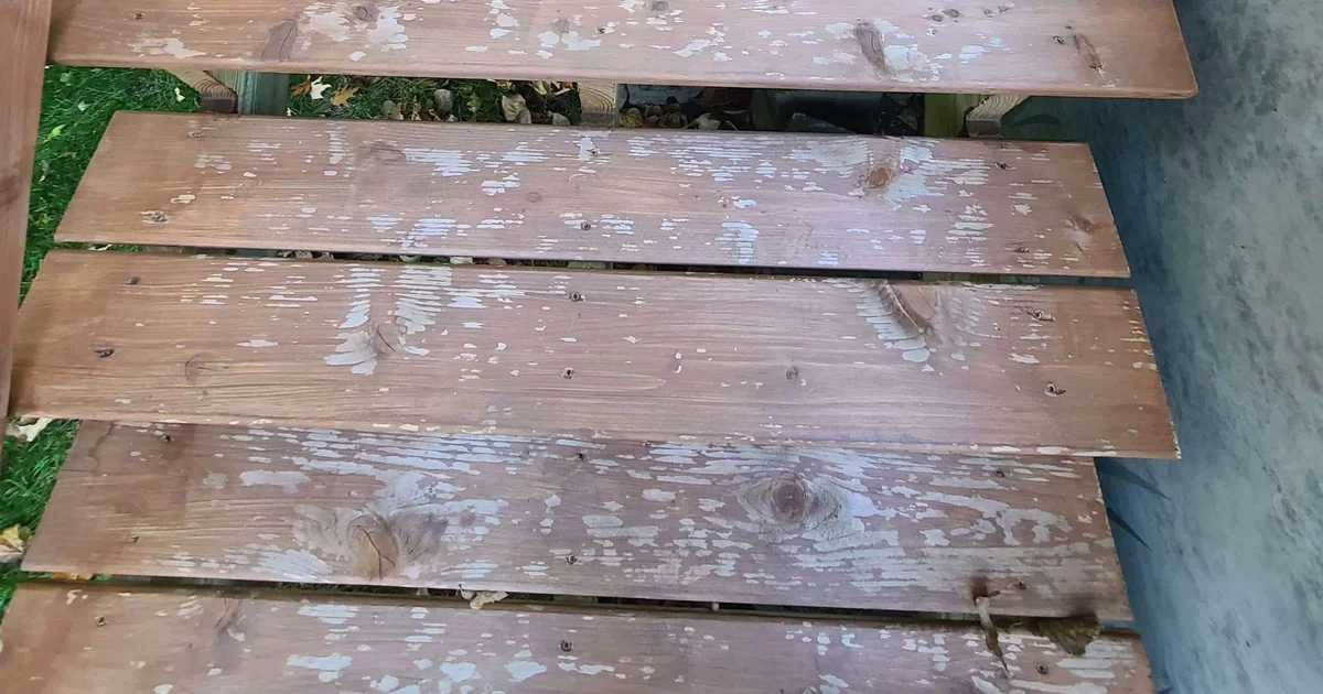 Peeling paint on deck boards caused by painting over wood that had not fully dried