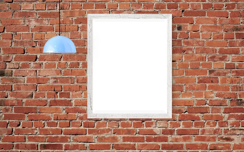 Framed picture mounted on brick with an adhesive hook Framed picture mounted on brick with an adhesive hook