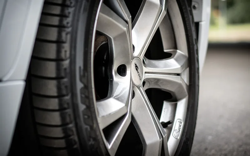 close-up of black rubber tire tread showing the non-porous surface that resists paint adhesion