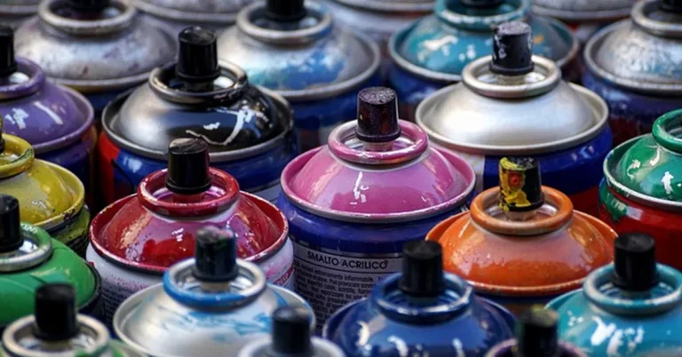 Rows of colorful spray paint cans similar to Rustoleum, used to illustrate drying time differences