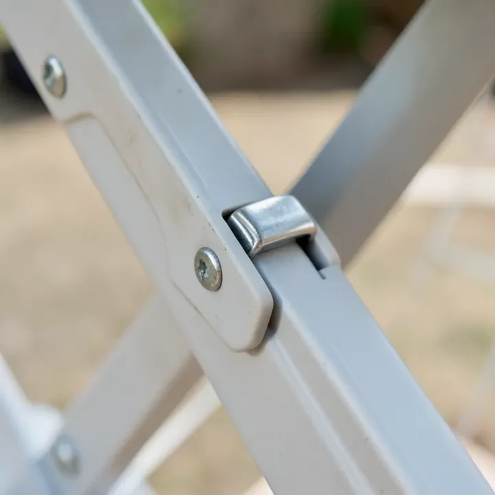 Spring-loaded height adjustment latch on a folding sawhorse leg