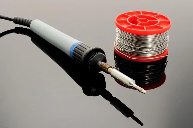 A soldering iron, one of the heated tools that can melt a clean hole through thin acrylic sheet